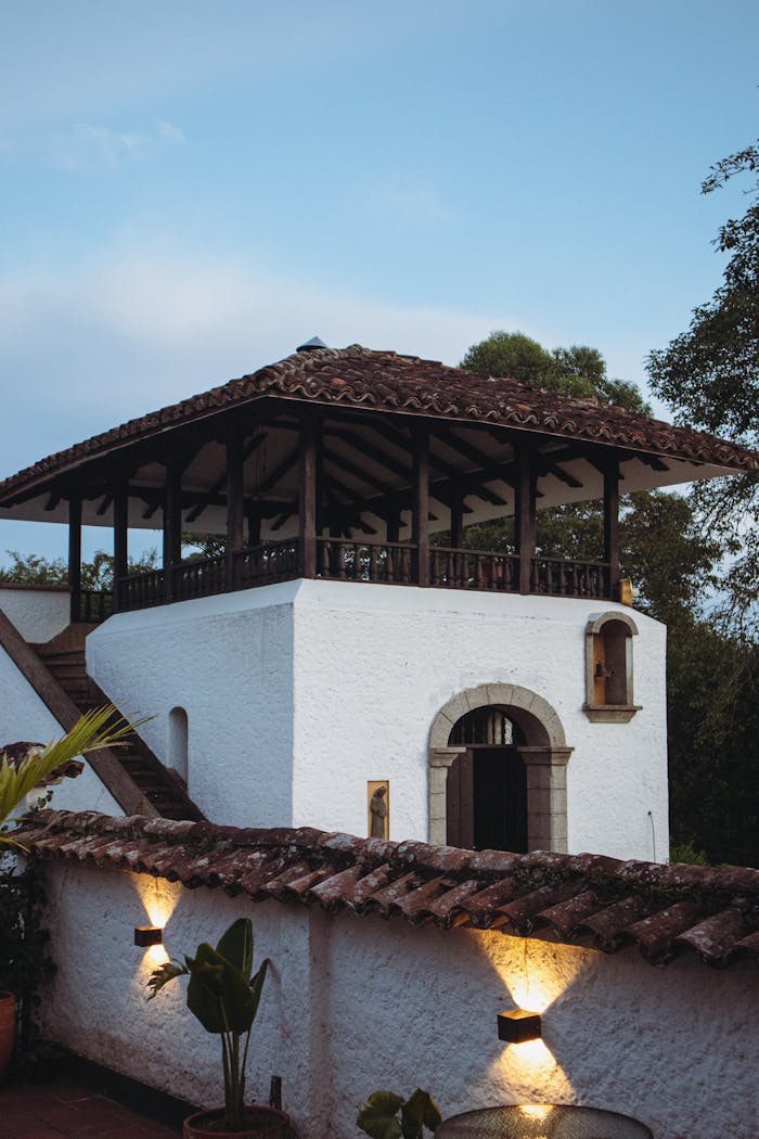 client-stories-img Charming rural house in CajibÃo, Colombia with classic architecture and a serene evening atmosphere.
