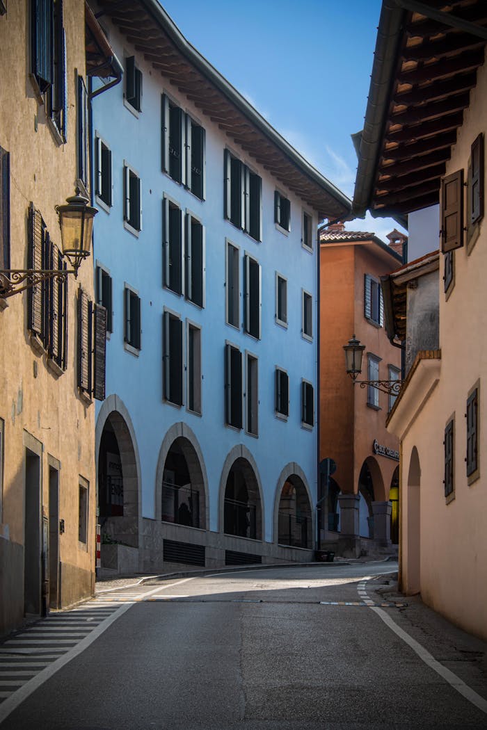 my-qualifications A picturesque scene of colorful architecture on a street in San Daniele del Friuli, Italy.