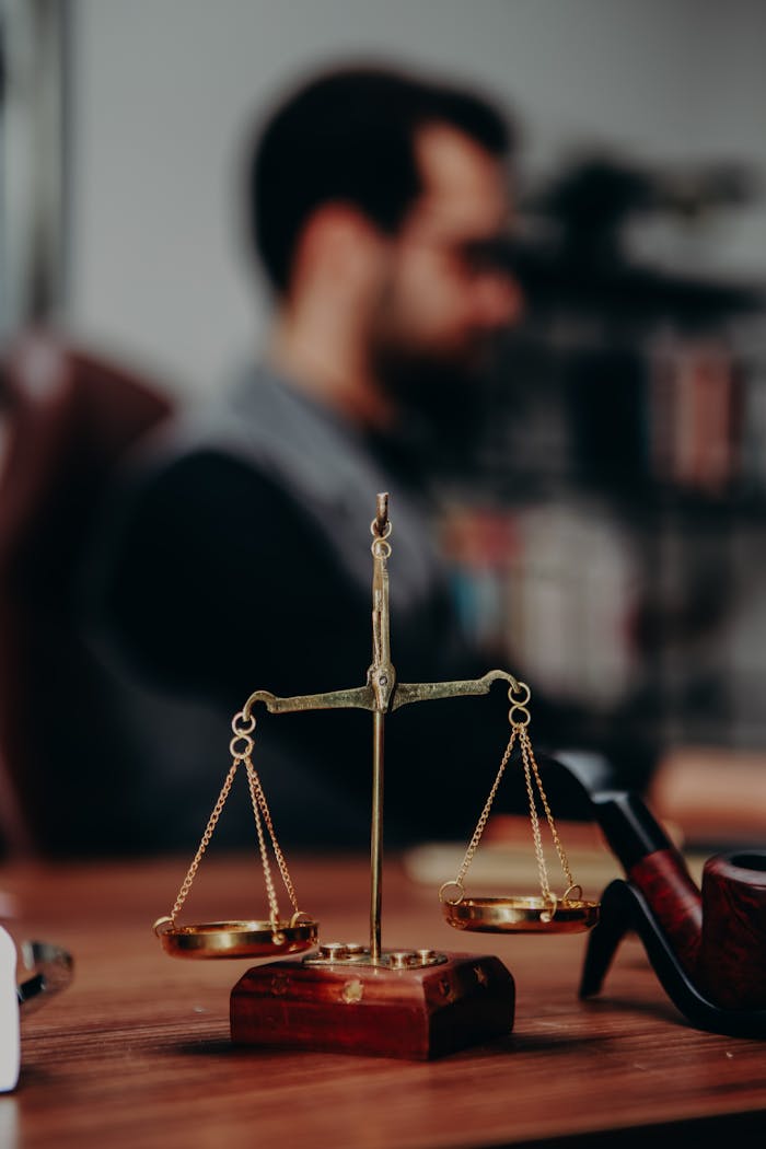 services-img Close-up of justice scales and pipe on a lawyer's desk, emphasizing legal themes.